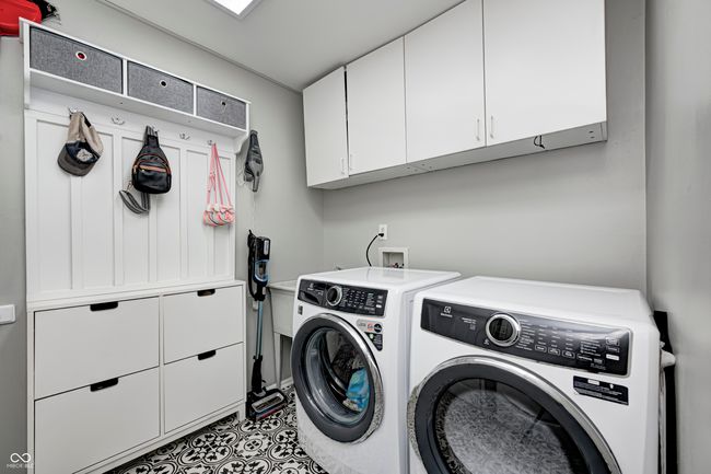 Spacious laundry room with built-in kid storage | Image 21