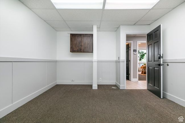 Basement with carpet floors and a drop ceiling | Image 17
