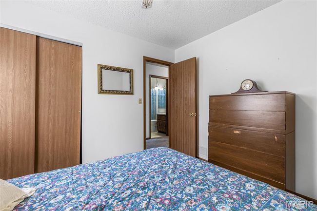 Bedroom with a textured ceiling and a closet | Image 29