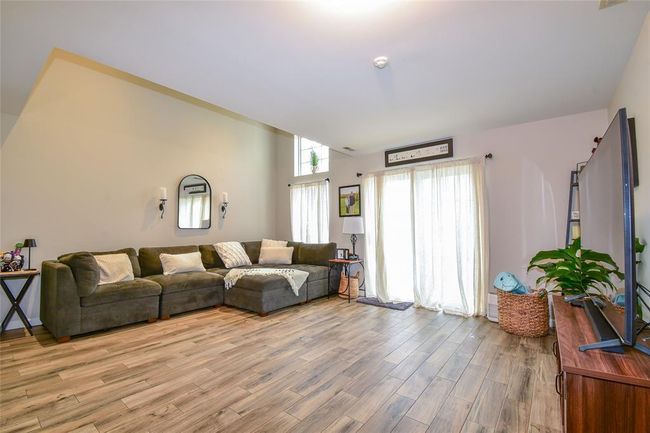 Living area with light wood-style floors | Image 4