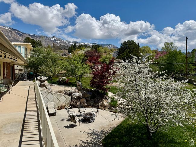 Balcony featuring an outdoor living space with a fire pit, a mountain view, and a patio | Image 22