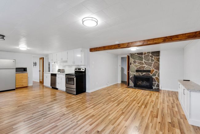 Stairs featuring concrete flooring and water heater | Image 22