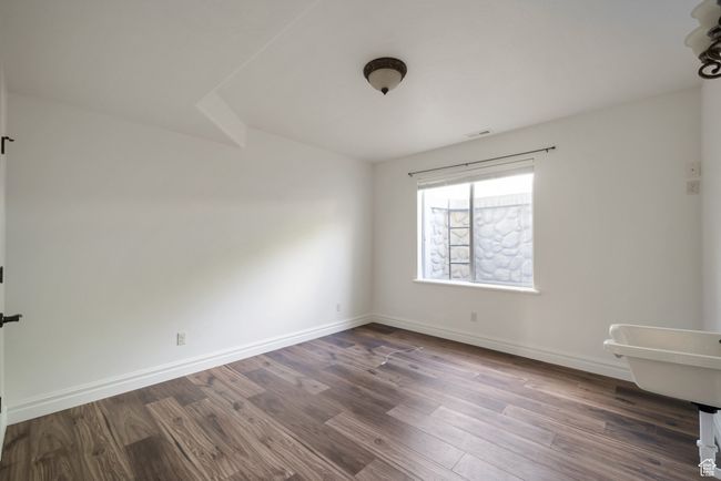 Spare room with visible vents, baseboards, and dark wood finished floors | Image 32