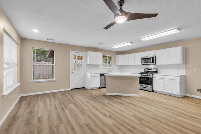 Beautiful kitchen with stainless steel appliances and open to breakfast and dining areas. | Image 16