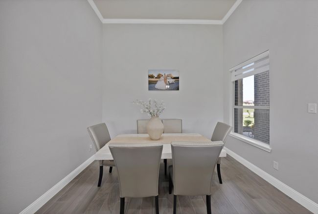 Dining area featuring crown molding, baseboards, and wood finished floors | Image 16