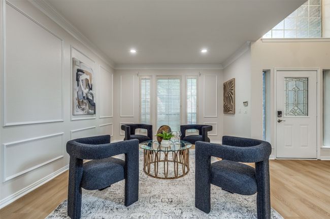 Sitting room featuring wood finished floors, ornamental molding, a decorative wall, and recessed lighting | Image 8