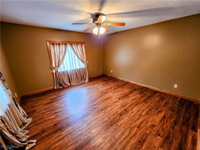 Spare room with dark hardwood / wood-style floors and ceiling fan | Image 3