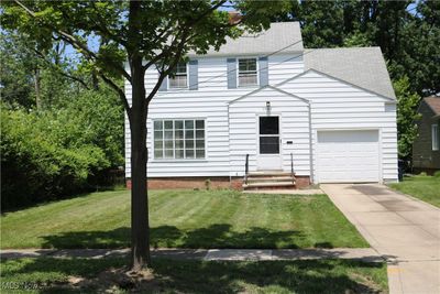 View of front of home featuring a garage and a front yard | Image 1