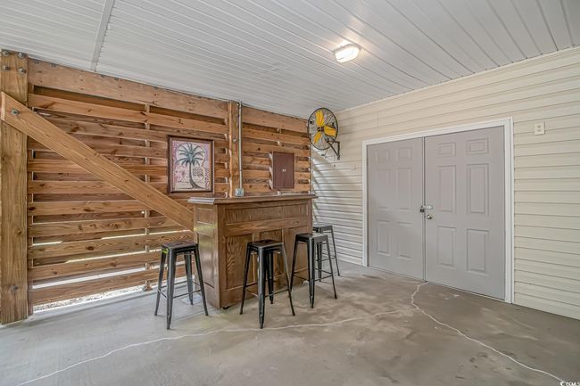 Bar area with wood walls and concrete flooring | Image 24