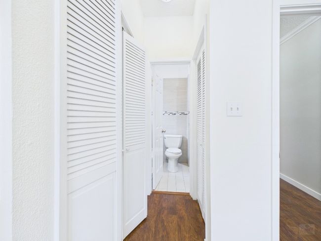 Hall featuring dark wood-style floors and crown molding | Image 23