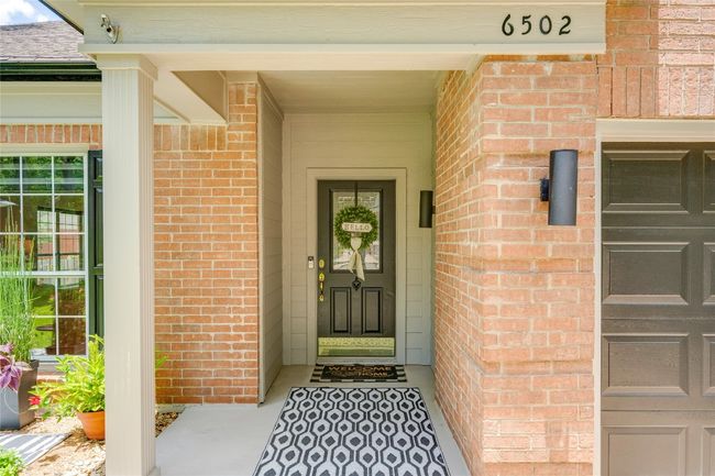 View of exterior entry with brick siding | Image 7