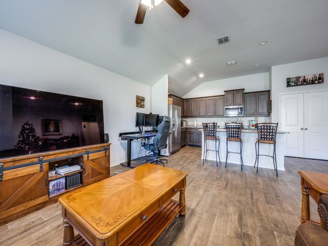 Living area with light wood-type flooring, lofted ceiling, ceiling fan, and recessed lighting | Image 14