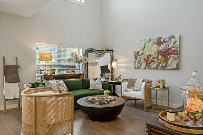Living room featuring a high ceiling and hardwood / wood-style flooring | Image 5