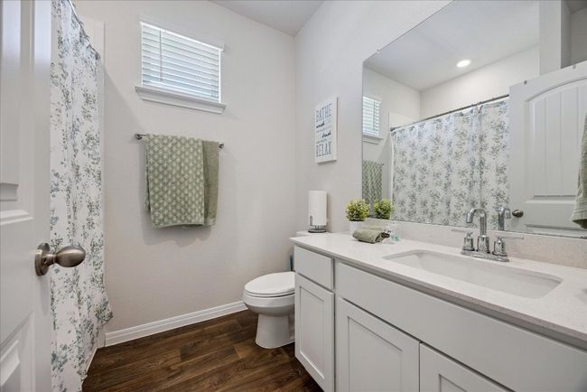 Bathroom with wood finished floors and vanity | Image 35