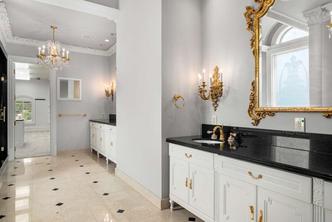 Full bath featuring vanity, a chandelier, tile patterned floors, and crown molding | Image 16