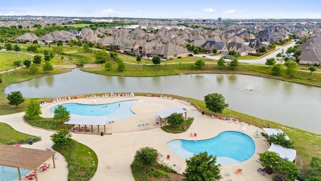 Aerial view of a pool area and a nearby body of water | Image 23