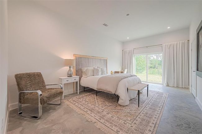 Primary bedroom with en suite bath and sliding glass doors to the back. | Image 15