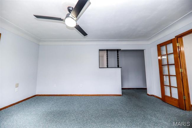 Carpeted spare room featuring a ceiling fan and baseboards | Image 5