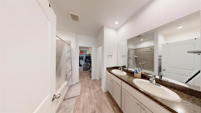 Double sink vanity, and the primary bedroom closet is at the end. | Image 26