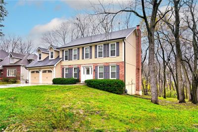 View of front facade featuring a garage and a front yard | Image 2