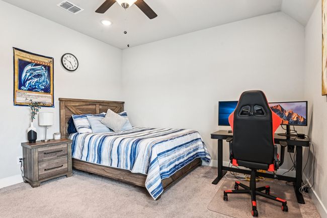 Bedroom with carpet flooring, a ceiling fan, recessed lighting, and vaulted ceiling | Image 24