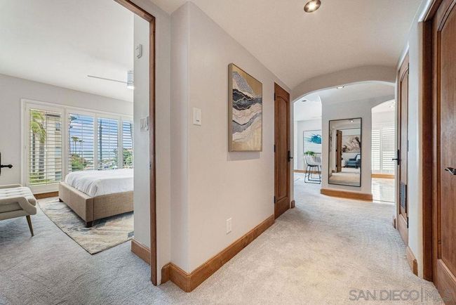 View from 2nd bedroom door of ocean and widened hallway to the living area. | Image 14