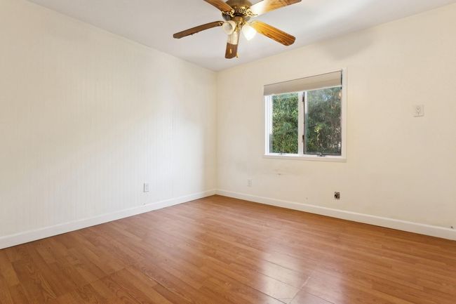Empty room featuring baseboards, light wood-style floors, and ceiling fan | Image 19