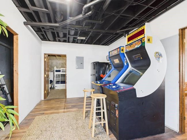 Recreation room with wood finished floors and electric panel | Image 62