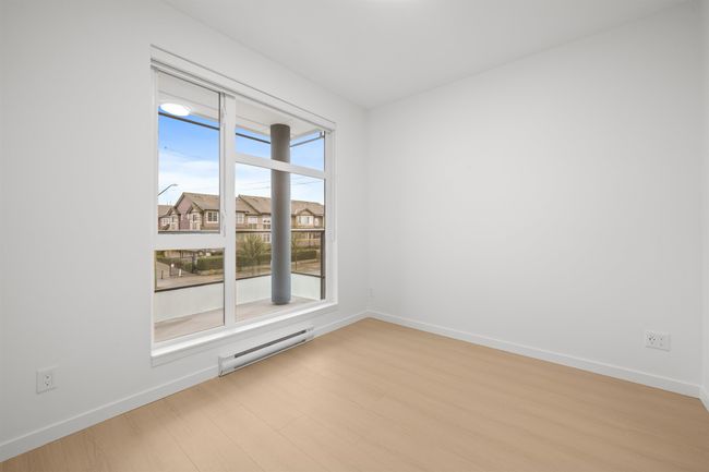 Empty room with a baseboard heating unit and light wood-type flooring | Image 11
