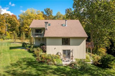 Back of house with a balcony and a yard | Image 3