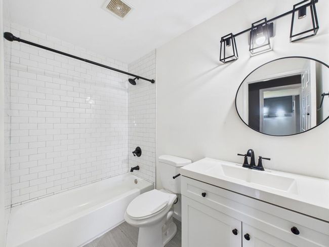 Bathroom featuring vanity and shower / tub combination | Image 19
