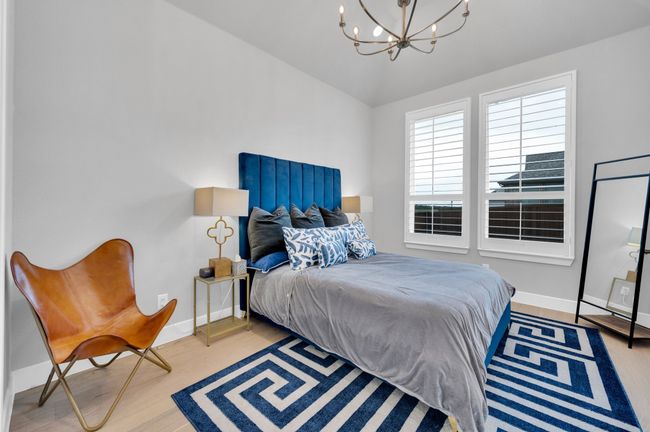 Bedroom with a chandelier, wood finished floors, and vaulted ceiling | Image 26