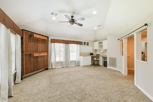 Upstairs, enjoy a spacious game room perfect for family fun and entertainment. | Image 27