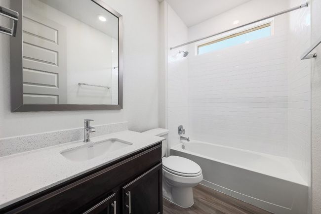 Full bathroom with wood finished floors, vanity, and tub / shower combination | Image 19
