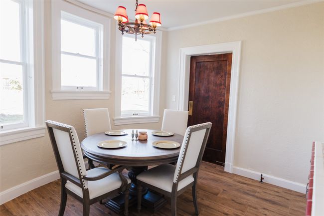 Dining area with radiator, dark hardwood / wood-style floors, a chandelier, and ornamental molding | Image 19