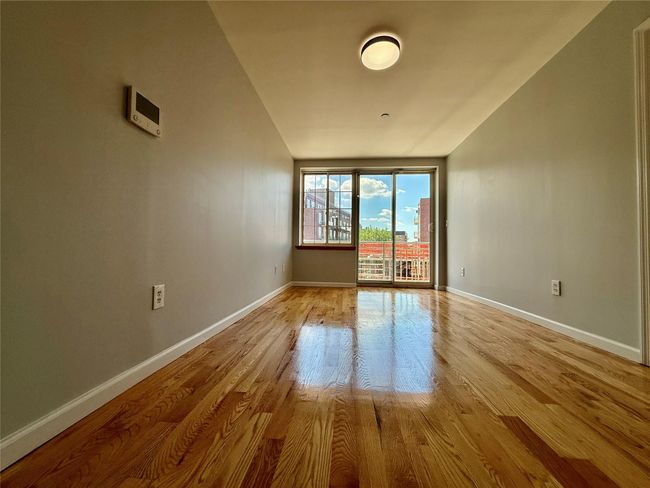 Spare room with baseboards and light wood-style flooring | Image 8