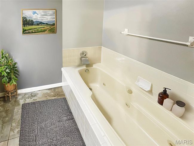 Full bathroom featuring a whirlpool tub | Image 9