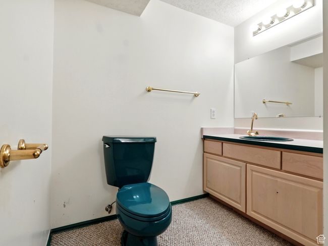 Bathroom featuring vanity and a textured ceiling | Image 13