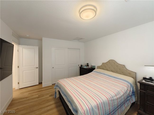 Bedroom with baseboards, light wood-style floors, and a closet | Image 28