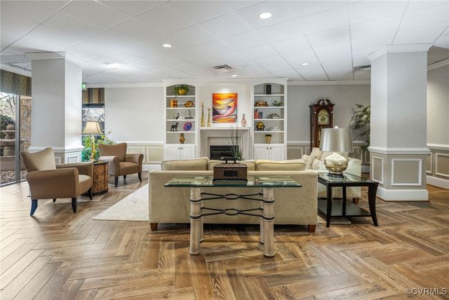 Living area featuring recessed lighting, ornamental molding, a wainscoted wall, a fireplace, and visible vents | Image 24