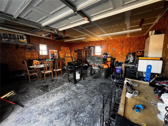 Garage featuring a workshop area | Image 24