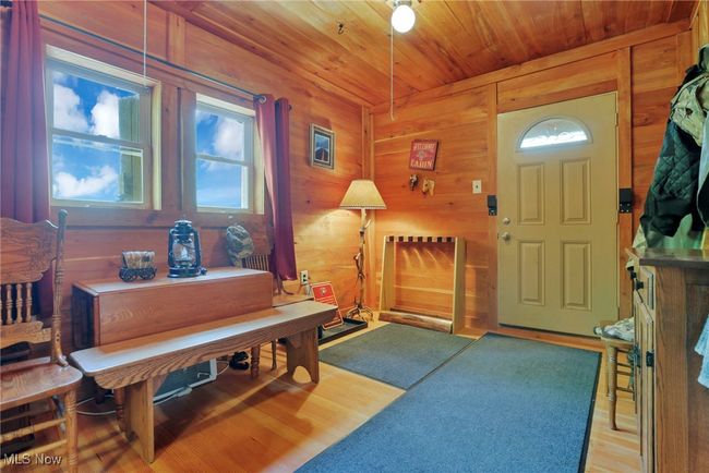 Entryway with wood ceiling, wood walls, and light wood-type flooring | Image 9