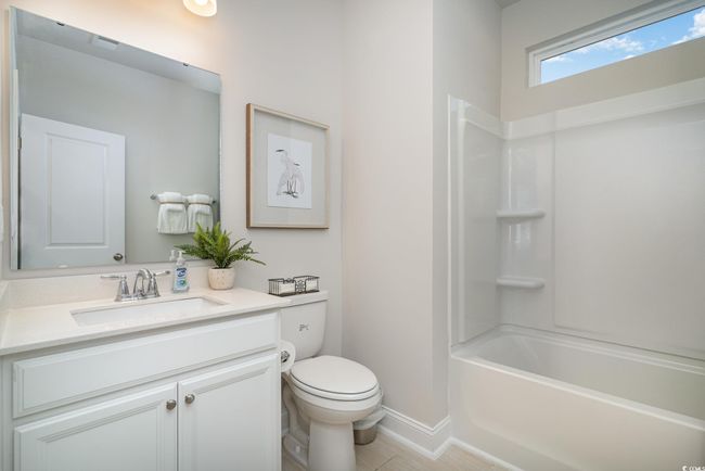 Bathroom with vanity, toilet, baseboards, and shower / bath combination | Image 13
