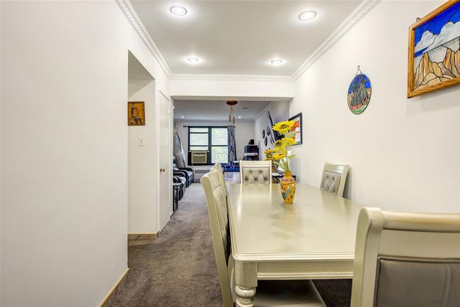 Carpeted dining room with ornamental molding and cooling unit | Image 5