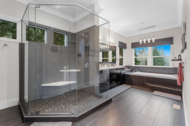 Full bath featuring a bath, a shower stall, crown molding, and vanity | Image 18