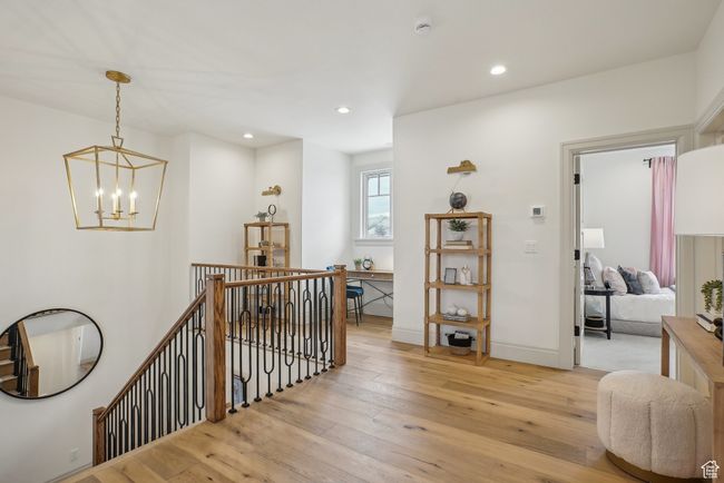 Corridor featuring recessed lighting, light wood-style flooring, an inviting chandelier, an upstairs landing, and baseboards | Image 29