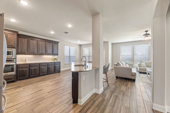 Kitchen with light wood-style floors, healthy amount of natural light, ceiling fan, and recessed lighting | Image 9