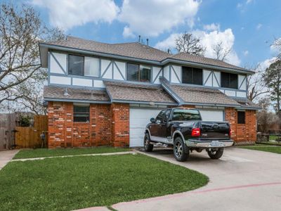 English style home with a garage and a front yard | Image 1