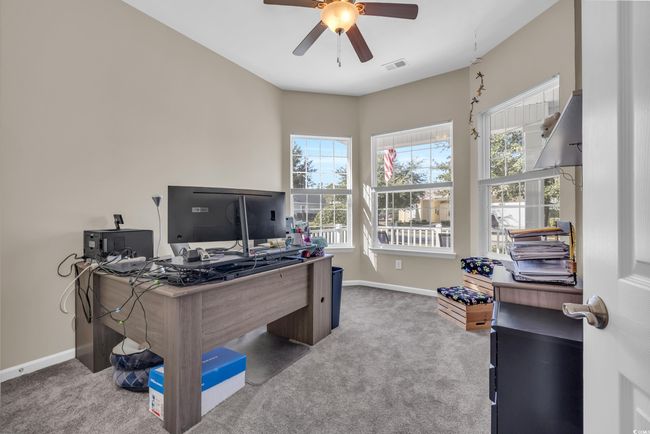 Carpeted home office featuring ceiling fan | Image 10