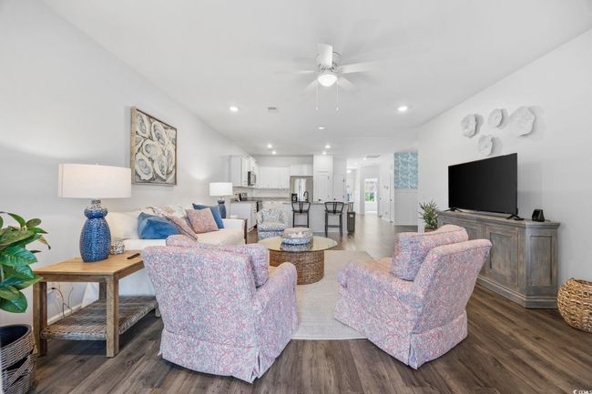 Living area featuring dark wood finished floors, ceiling fan, and recessed lighting | Image 15